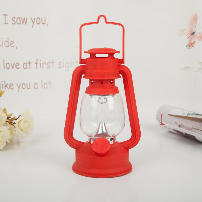 Portable rechargeable LED hurricane lantern with hanging handle and clear glass globe