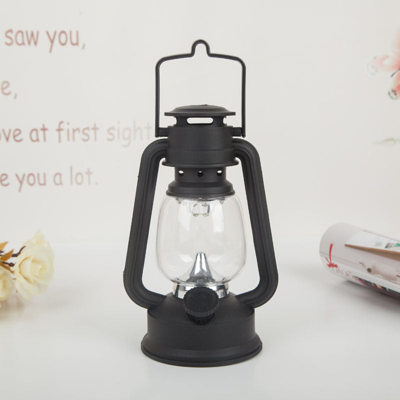 Portable rechargeable LED hurricane lantern with hanging handle and clear glass globe
